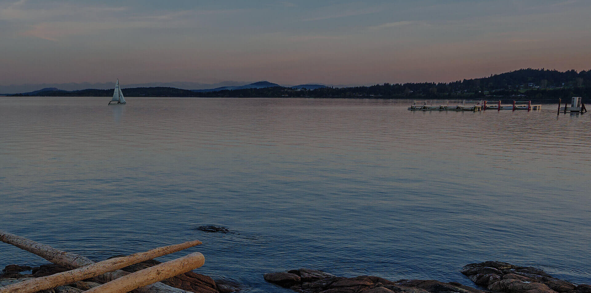 Hazy sunset looking across the water at the coastline